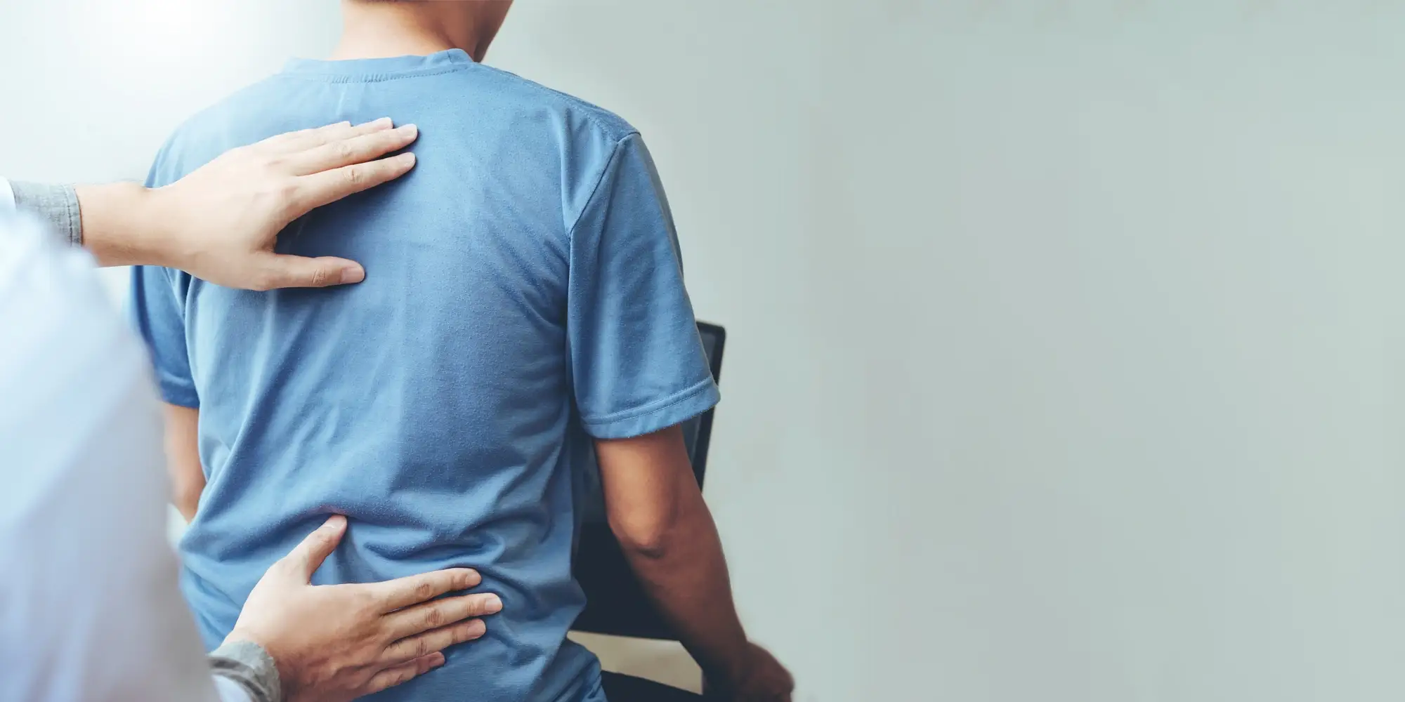 A chiropractor performing a back exam.